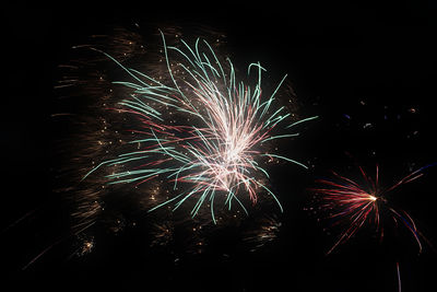 Low angle view of firework display at night