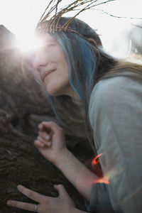 Close up celtic styled delighted woman face in bright sunlight portrait picture