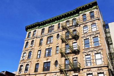 Low angle view of building against blue sky