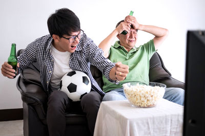 Friends watching soccer on tv