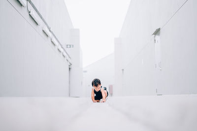 Portrait of woman sitting on wall