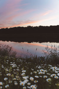 Scenic view of lake against sky at sunset