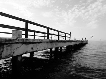 Tired bridge against the wild sea