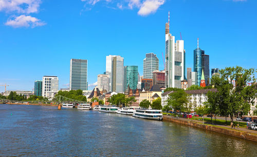 Canal amidst buildings in city against sky