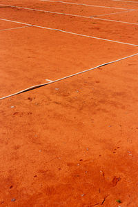 High angle view of lines on orange dirt at playing field