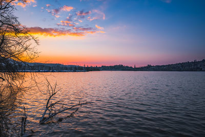 Scenic view of lake against sky during sunset