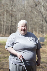 Portrait of young man standing in forest