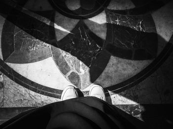 Low section of woman standing on tiled floor