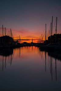 Sailboats in marina at sunset