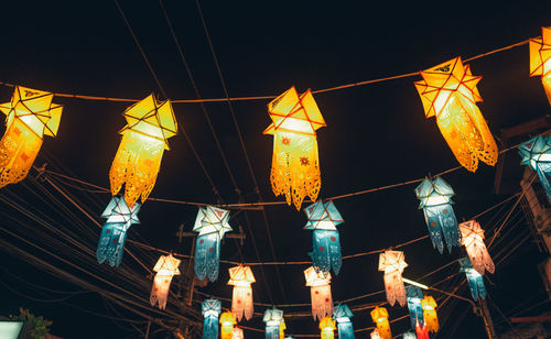 Low angle view of illuminated lanterns at night