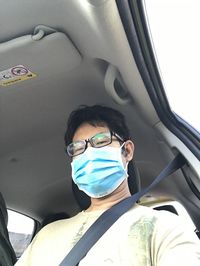 Portrait of man sitting in car