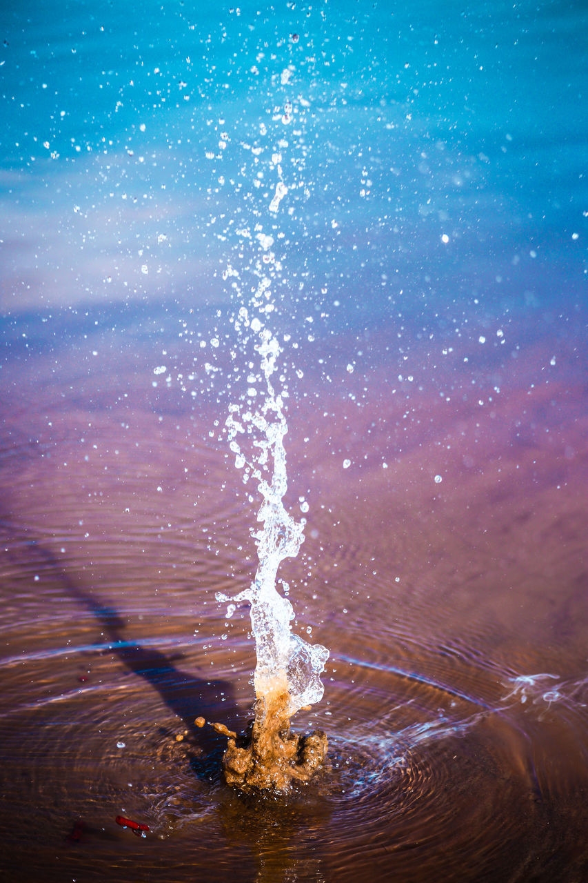 SCENIC VIEW OF SEA WAVES SPLASHING ON ROCKS