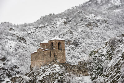 Scenic view of old building against sky during winter