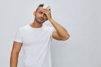 Rear view of man wearing hat against white background