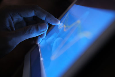 Close up of man hand analyzing chart on digital tablet