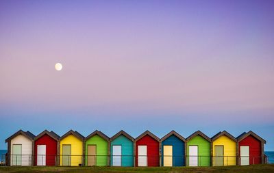 Multi colored umbrellas on beach against clear sky