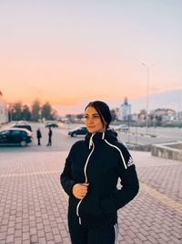 Portrait of woman standing against sky during sunset