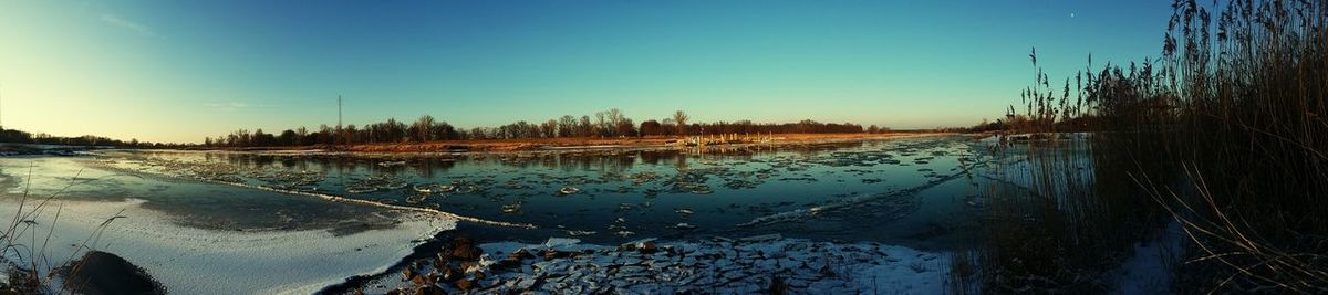 Scenic view of calm lake against clear sky