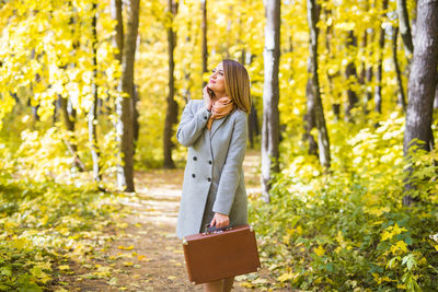 Woman standing in forest