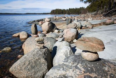 Stack of stones on beach against sky