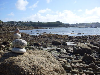 Rocks in sea against sky