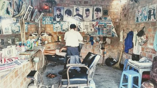 Rear view of man working on chair