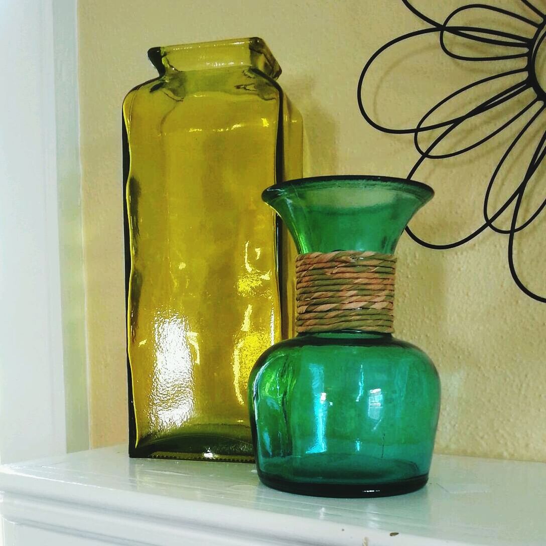 indoors, glass - material, still life, table, drink, transparent, close-up, bottle, home interior, drinking glass, no people, refreshment, container, glass, illuminated, single object, wall - building feature, jar, reflection, empty