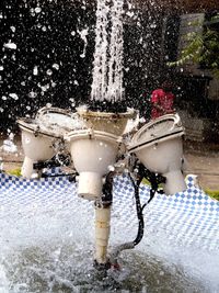 Water splashing in fountain at park during winter