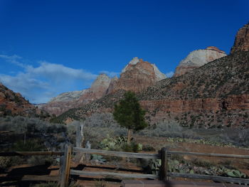 Scenic view of mountains against blue sky