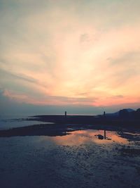 Scenic view of beach against sky during sunset