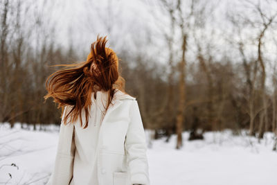 Woman with hair in front of face during winter