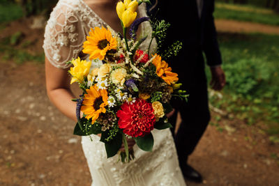 Close-up of woman holding bouquet of flowers