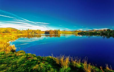 Scenic view of lake against blue sky