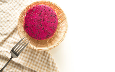 High angle view of pink glass against white background