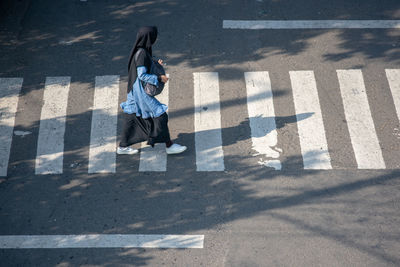 High angle view of man crossing road