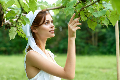 Side view of young woman looking away