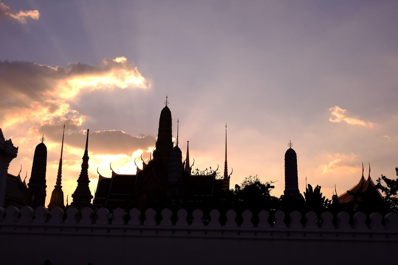 SILHOUETTE OF TEMPLE AGAINST BUILDING