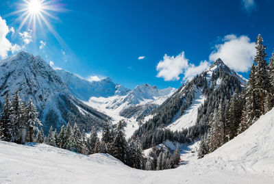 Scenic view of snow covered mountains against sky