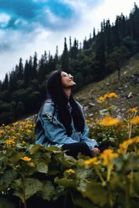 Side view of a young woman standing on land