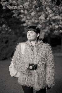 Portrait of young woman standing outdoors