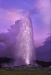 Panoramic view of waterfall against cloudy sky