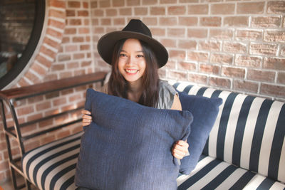 Portrait of young woman on sofa