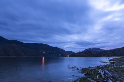 Scenic view of lake against sky at dusk