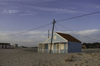 Houses on beach against sky