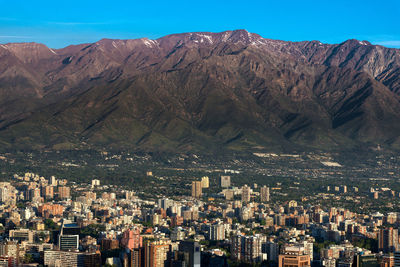 The andes mountain range with buildings of the wealthy district of providencia in santiago de chile.