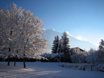 Scenic view of snow covered mountains against sky