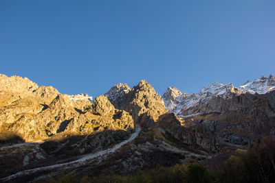 Scenic view of mountains against clear blue sky