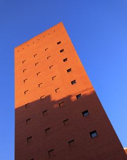 Low angle view of building against clear blue sky