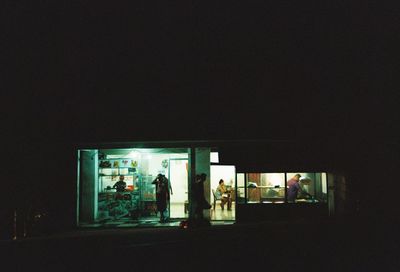 People walking in illuminated building