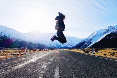 Full length of man on snowcapped mountain against sky